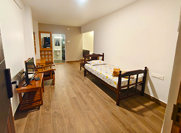 Deluxe Quadruple Room – Hornbill Castle Homestay Valparai Deluxe quadruple room at Hornbill Castle Homestay Valparai